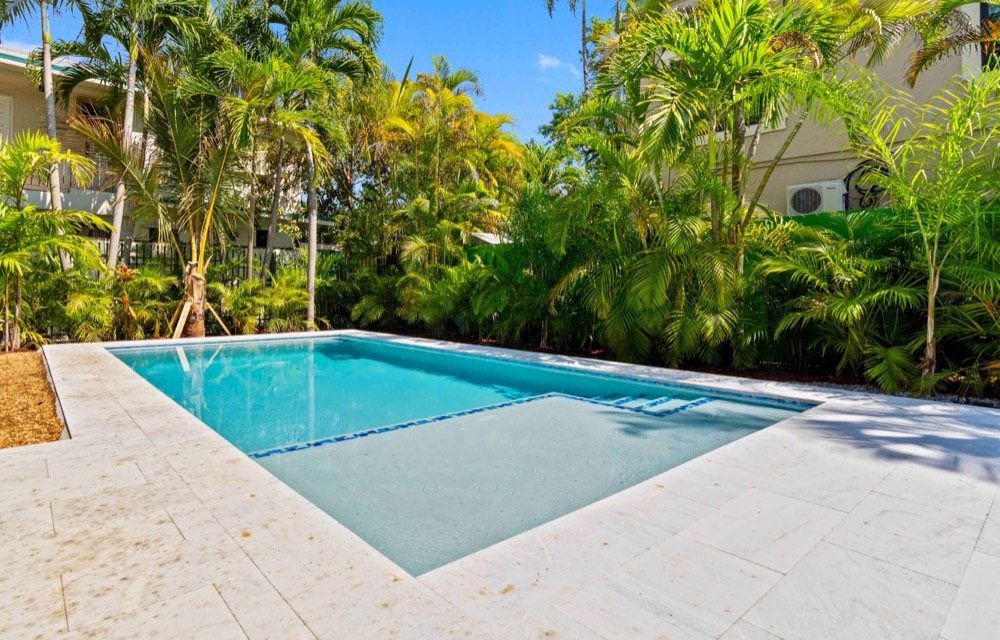 Private turquoise pool framed by palms