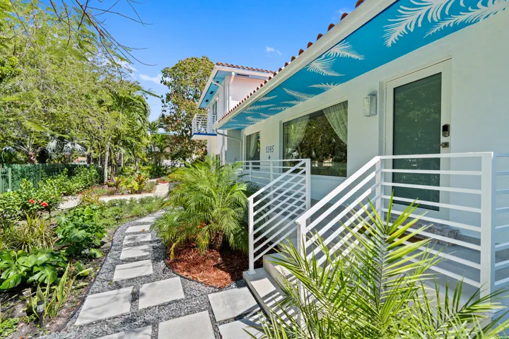 Exterior front of the residence with tropical landscaping