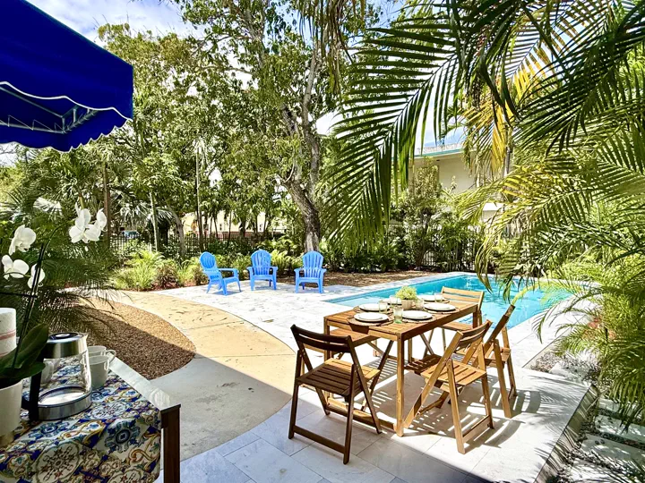 Pool deck lounge seating under the trees