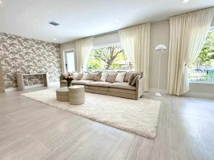 Living room with sectional sofa and curtained windows