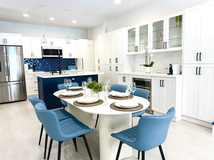 Chef's kitchen with island and blue dining chairs