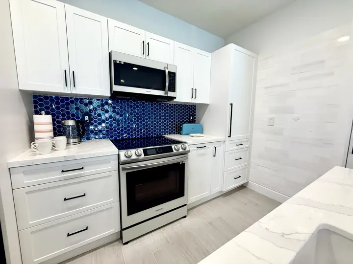 Kitchen with blue tile backsplash and range